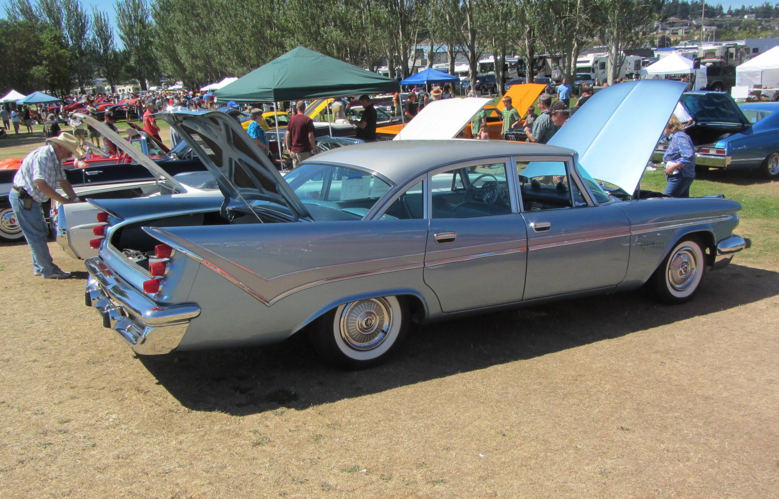 Classic four-door sedan with pronounced tailfins and wide whitewall tires