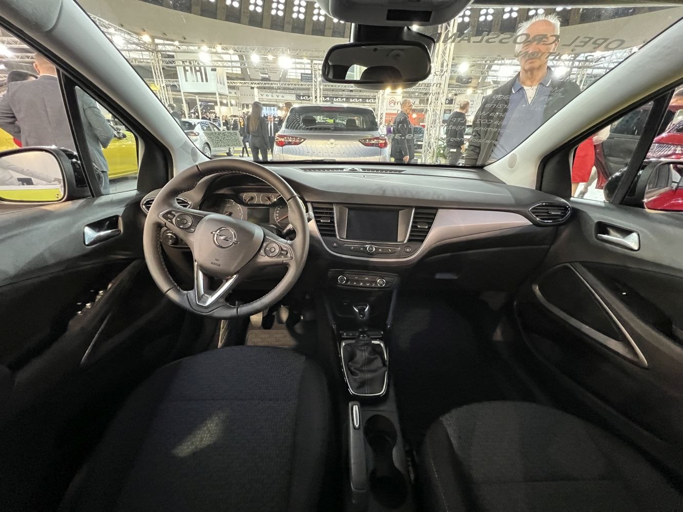 Car interior with multifunction steering wheel and dashboard display