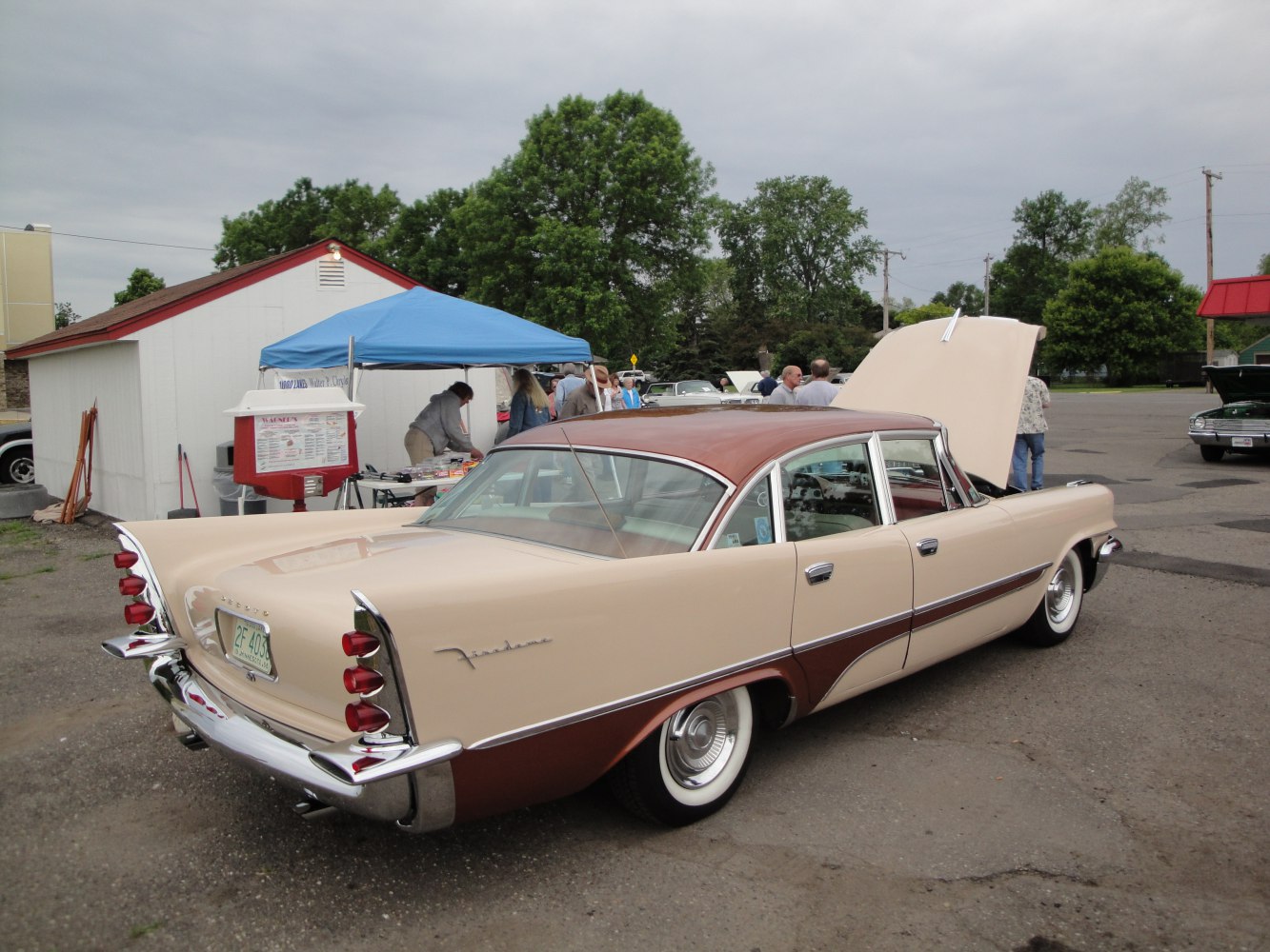 Distinctive rear fender fins and triple stacked round tail lights on a classic 1950s sedan