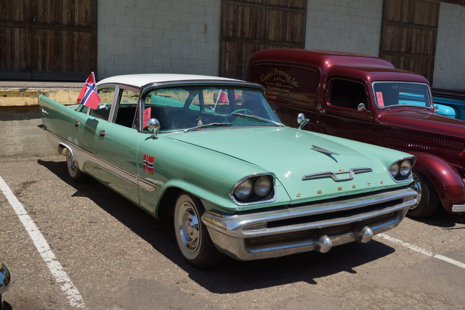 Classic 1950s sedan with dual round headlights and two-tone paint.