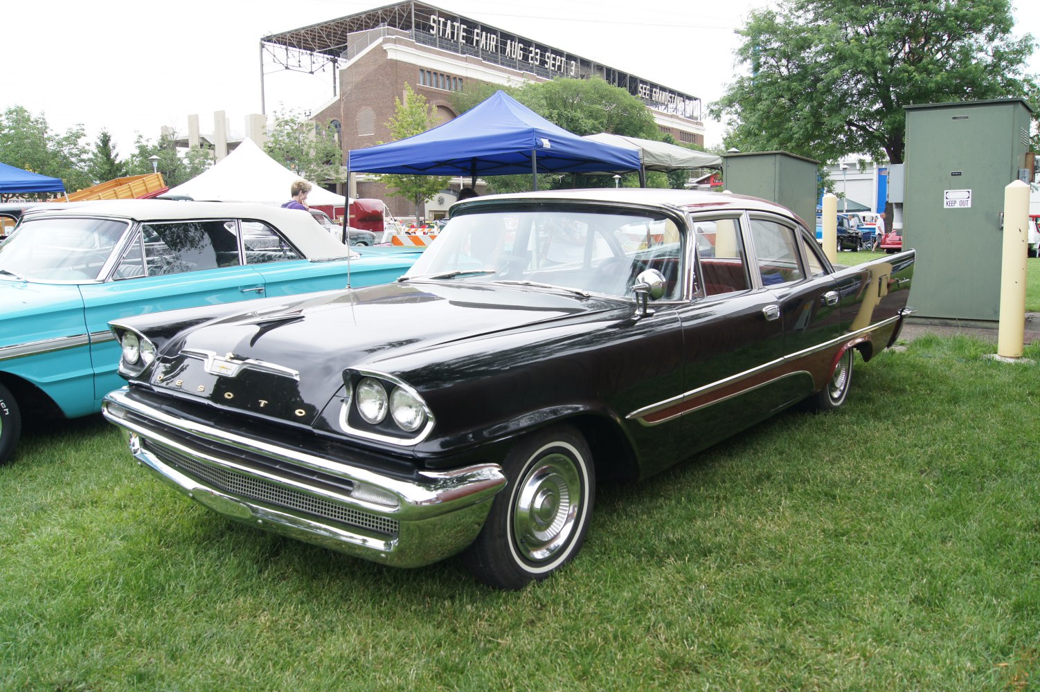 Black four-door sedan with dual round headlights and chrome trim