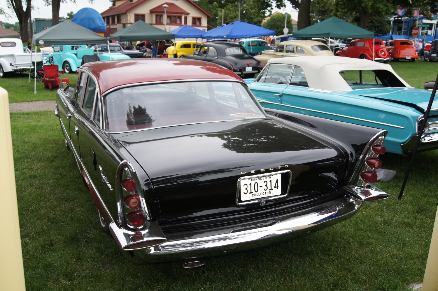 Rear view of classic sedan with tailfins and triple round taillights