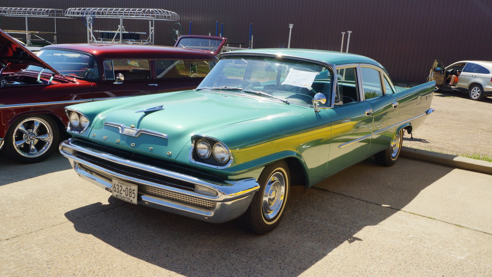 Classic four-door sedan with dual round headlights and chrome grille.