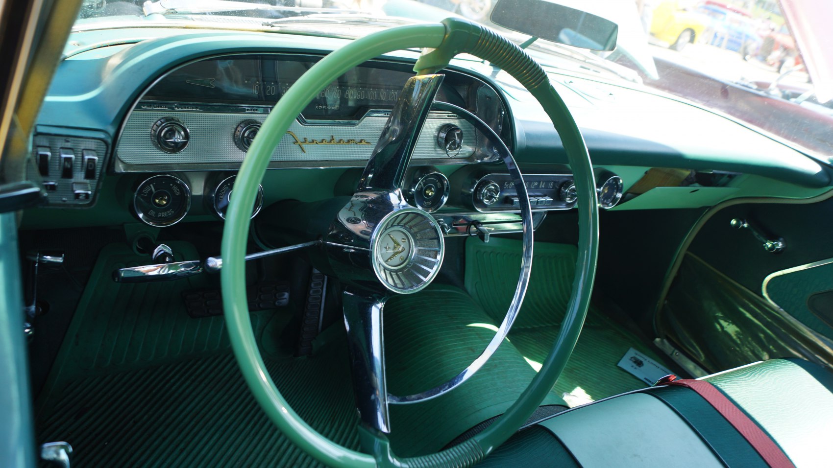 Vintage steering wheel with retro dashboard gauges in classic car interior