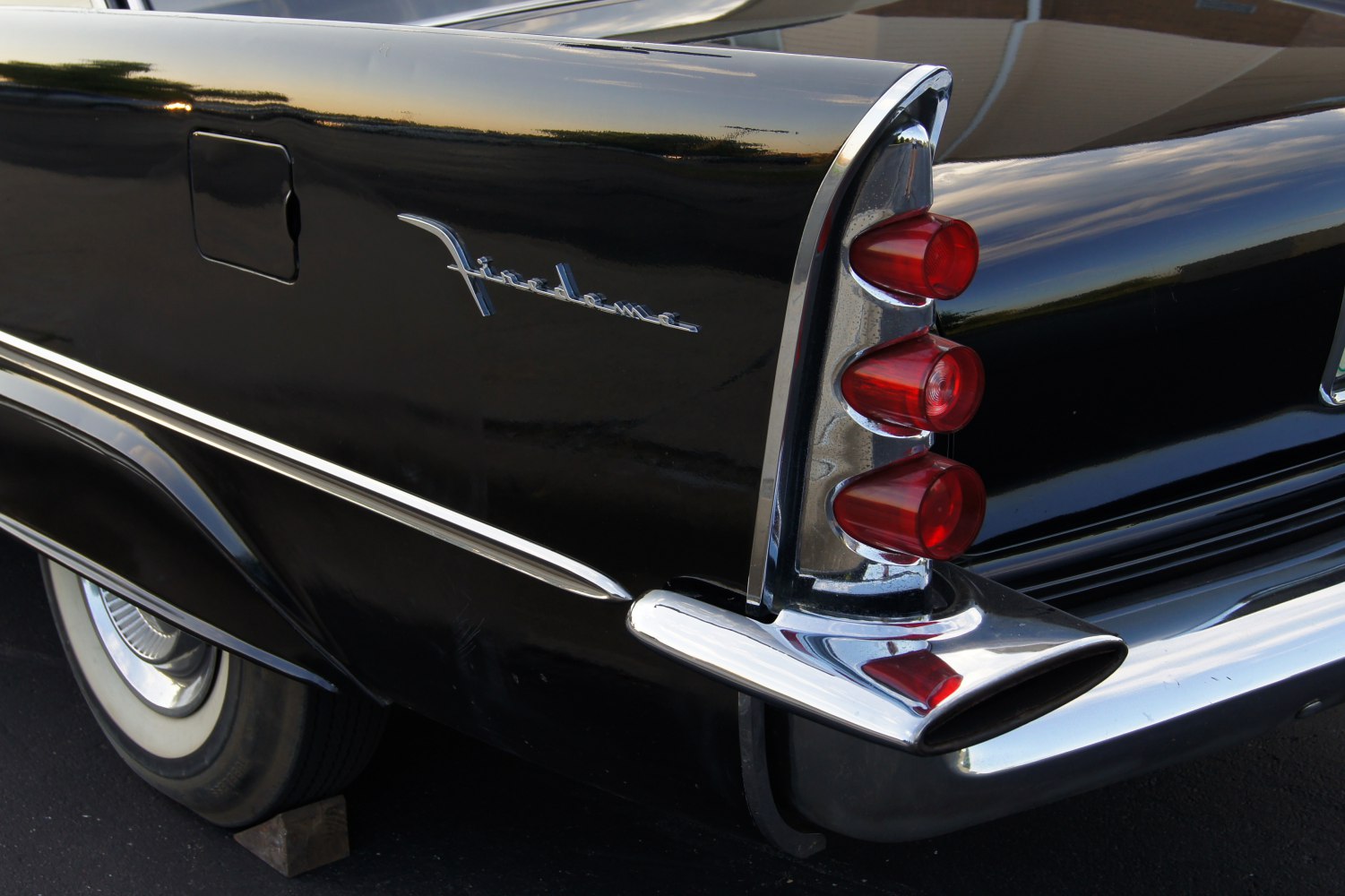 Vintage red triple tail light with chrome detail and Firedome badge