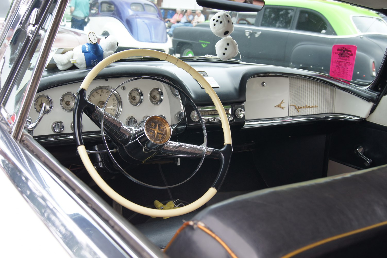 Vintage car interior with classic steering wheel and dashboard gauges
