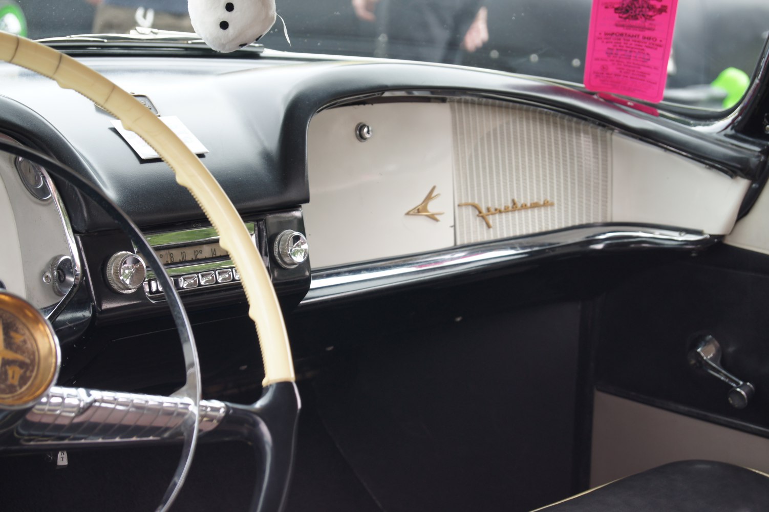 Classic 1950s car steering wheel and retro dashboard interior close-up
