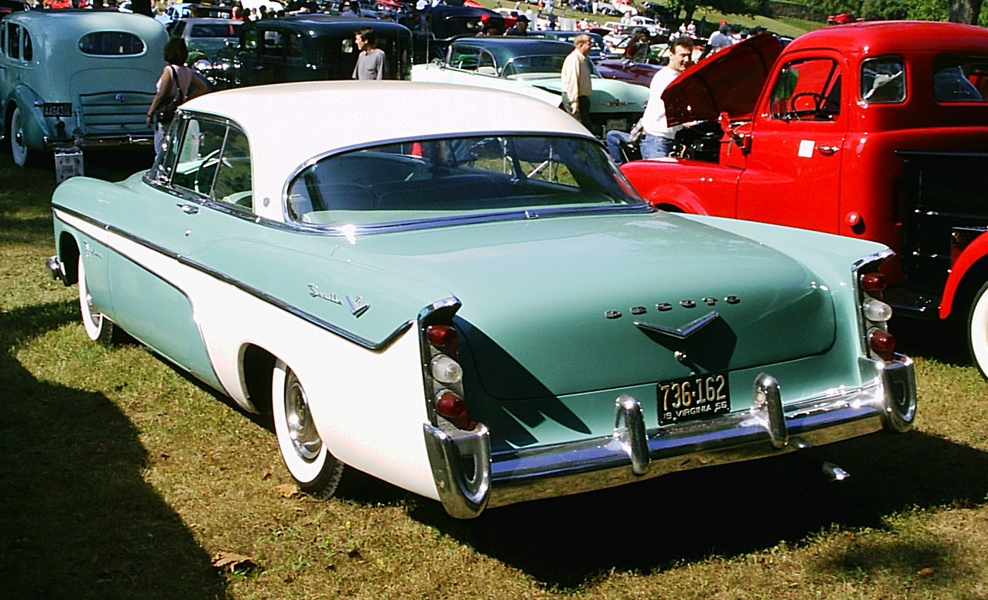 Rear view of a classic two-tone coupe with distinctive fins and chrome accents
