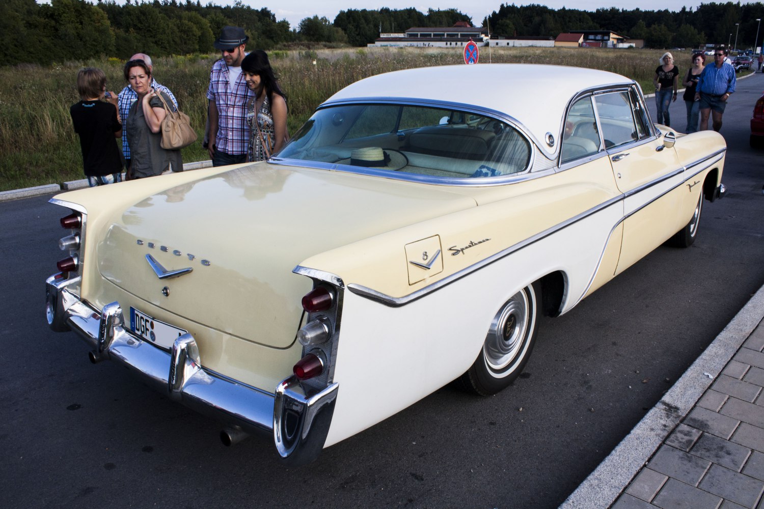 Rear view of 1950s two-tone sedan with tailfins and stacked triple tail lights