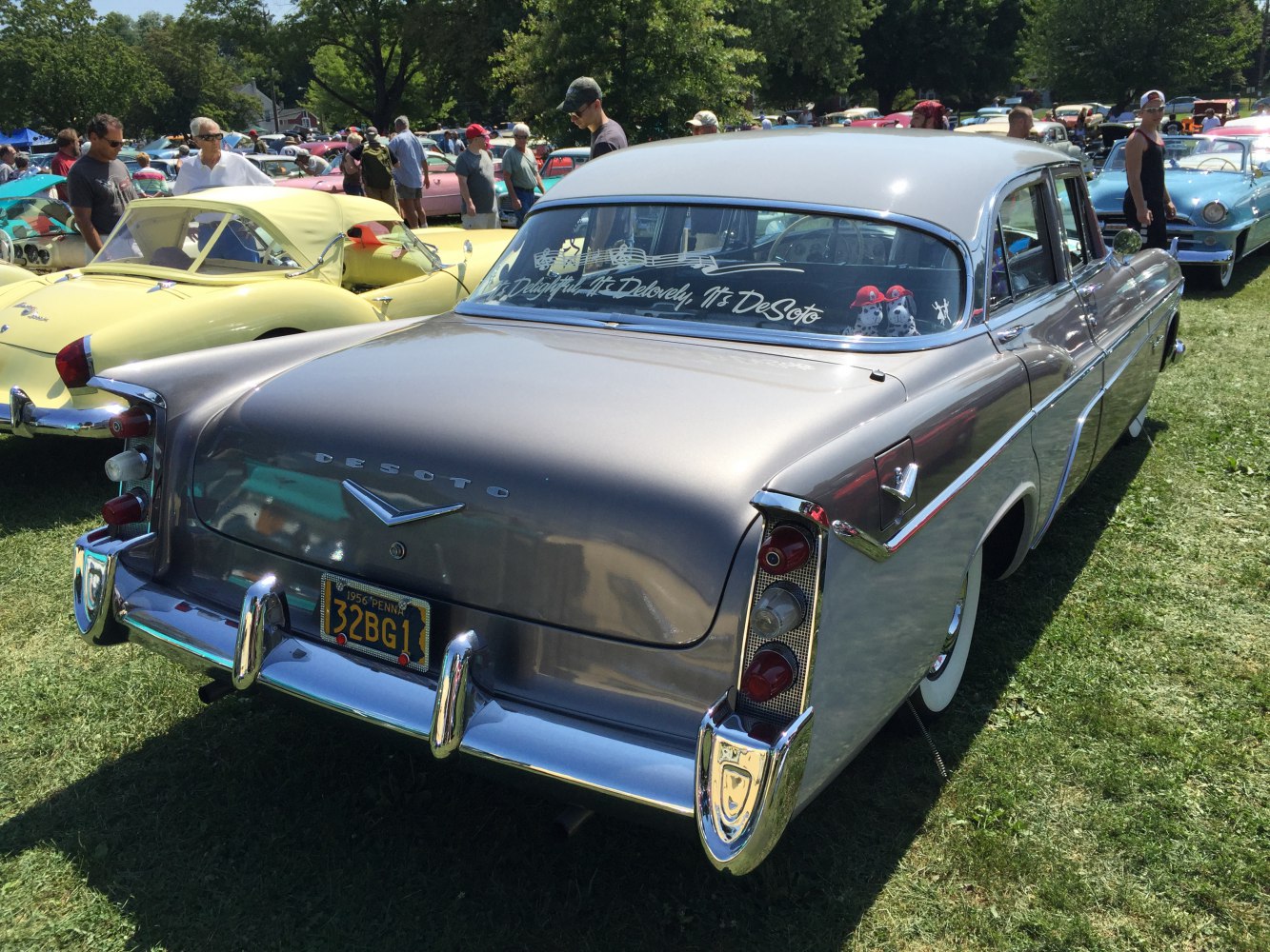 Rear view of classic sedan with prominent tailfins and chrome bumper
