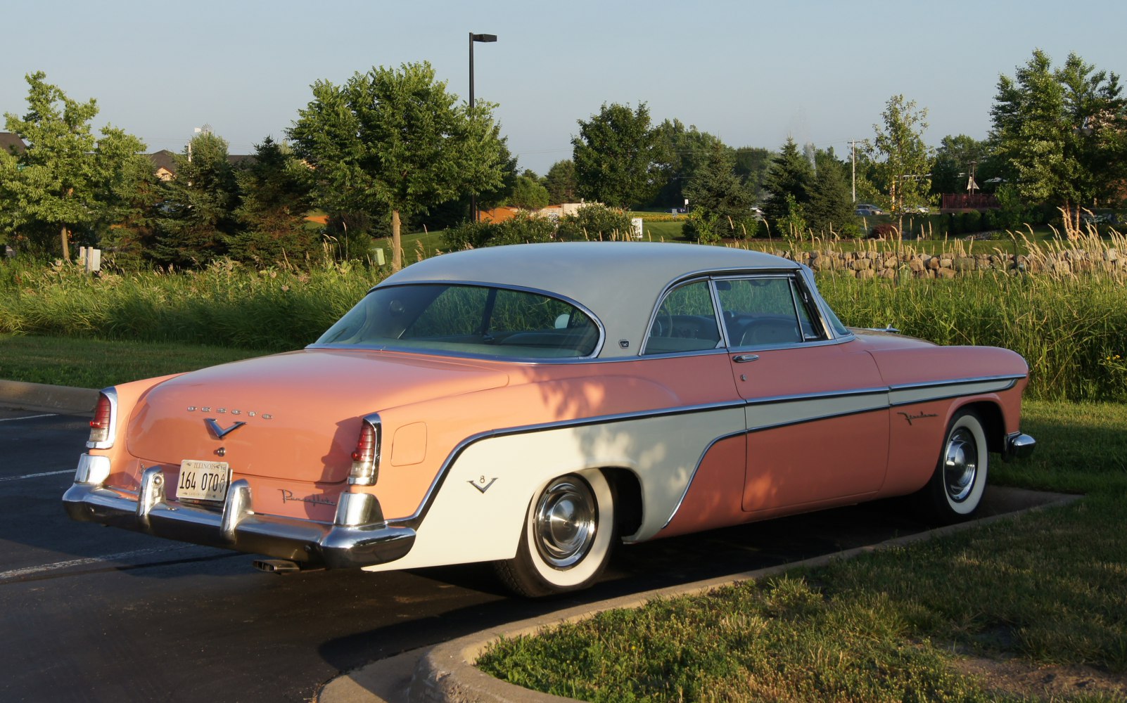 Two-tone vintage hardtop coupe rear side with classic taillights and whitewall tires