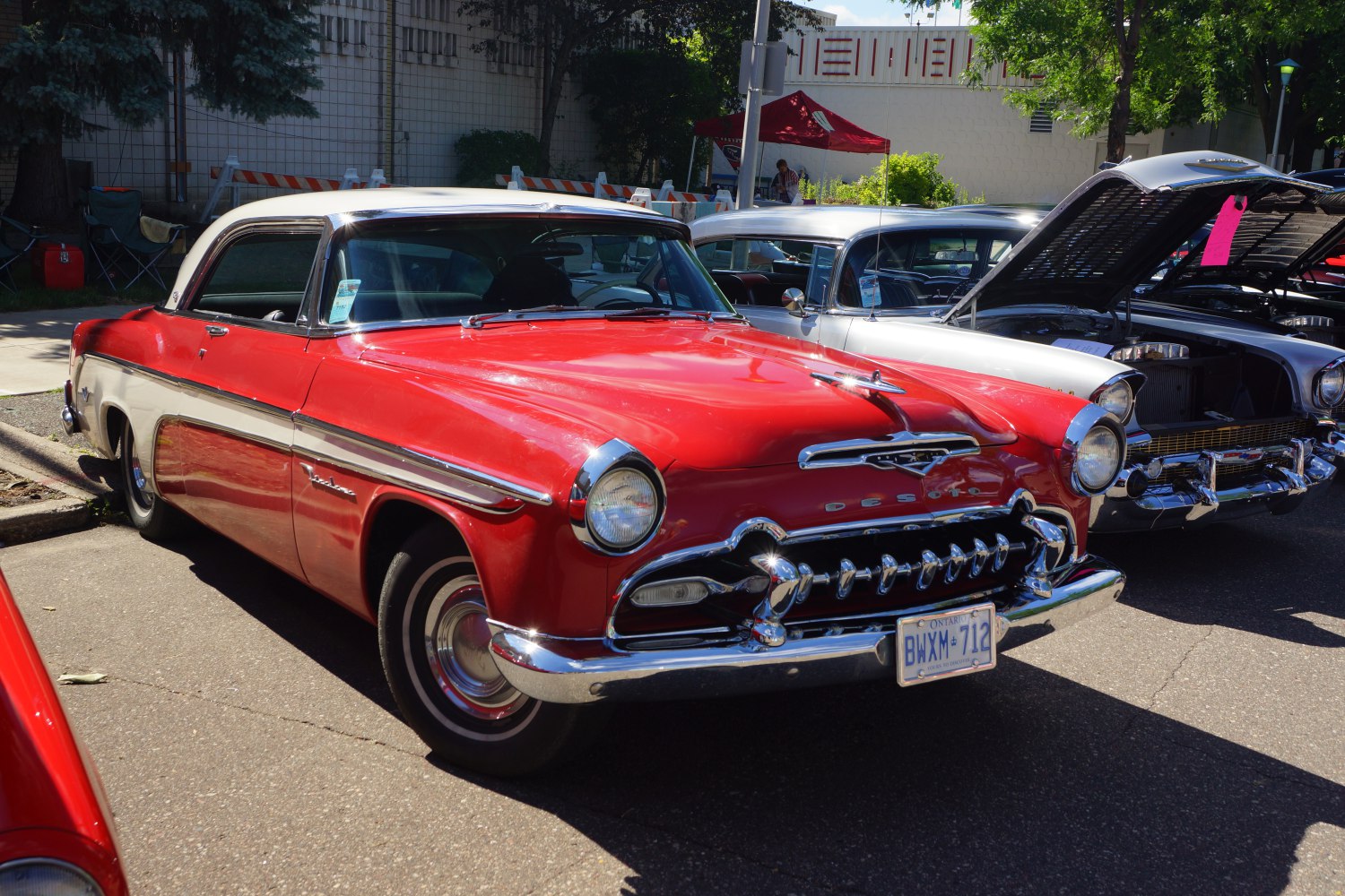 Classic 1950s two-tone coupe with chrome grille and vintage styling