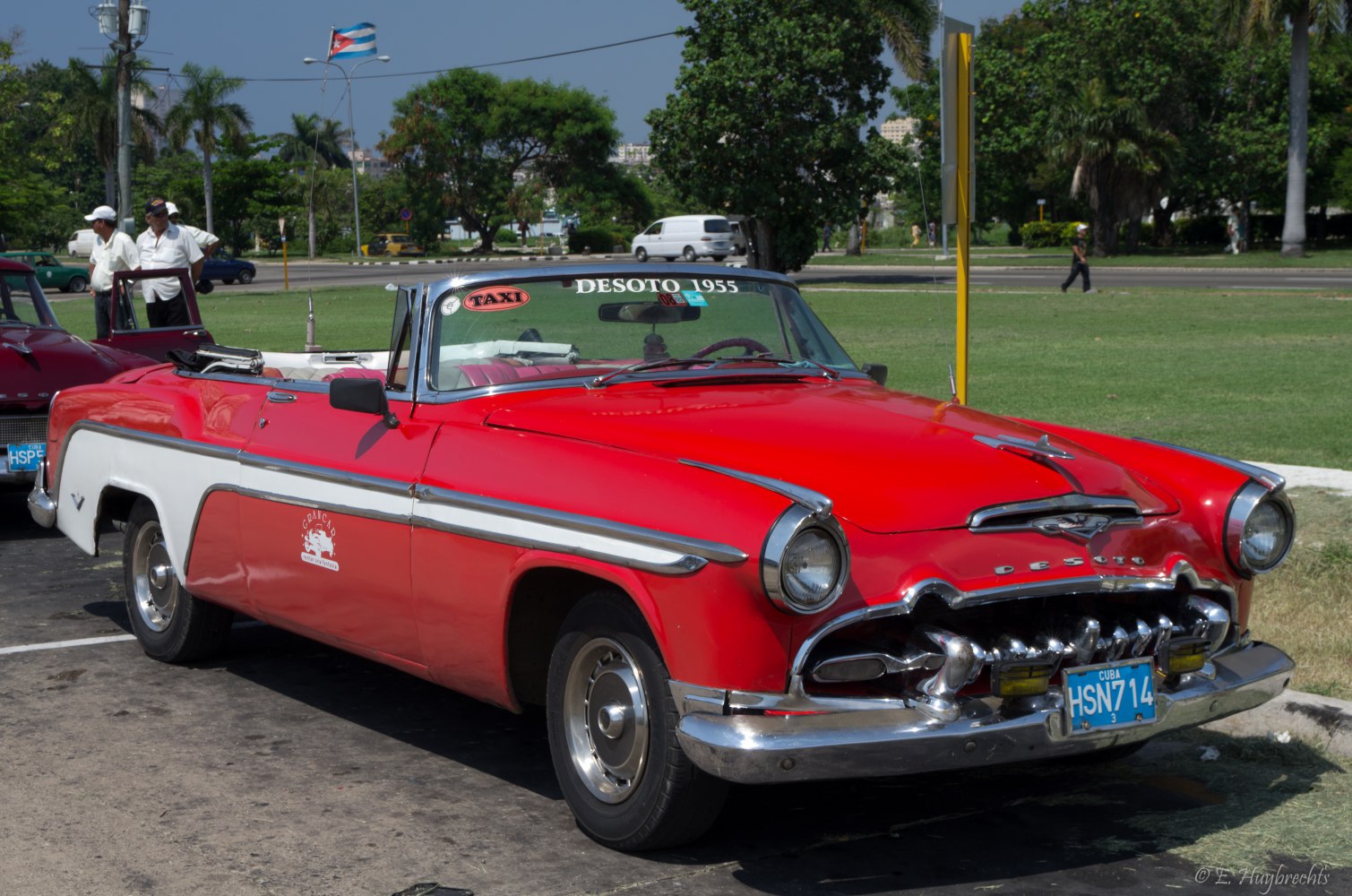 Red 1950s convertible with chrome trim and classic grille