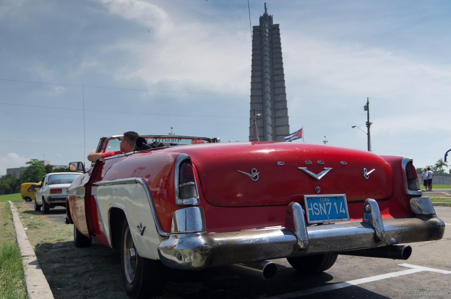 Rear view of vintage convertible with chrome bumper and dual exhaust