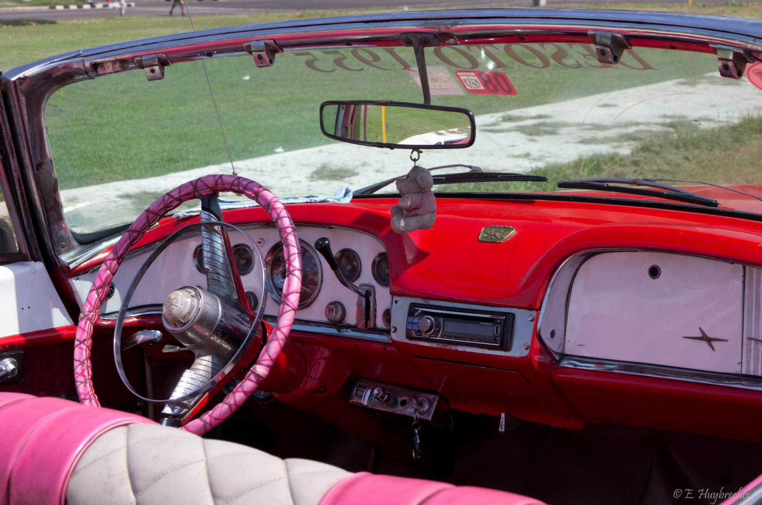 Classic vintage convertible interior with pink steering wheel and retro dashboard