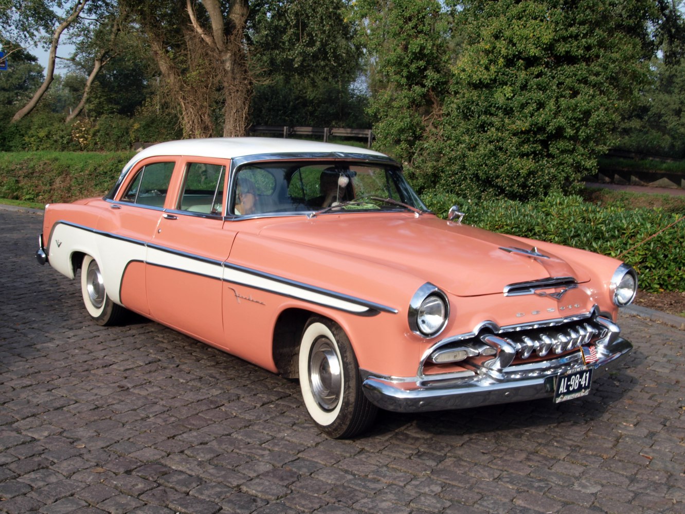 Classic front and side view of two-tone 1950s sedan with distinctive chrome grille