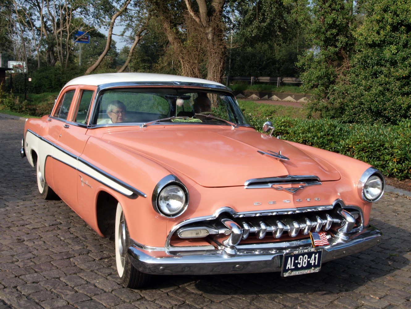 Distinctive chrome grille and two-tone pastel paint on a classic four-door sedan.