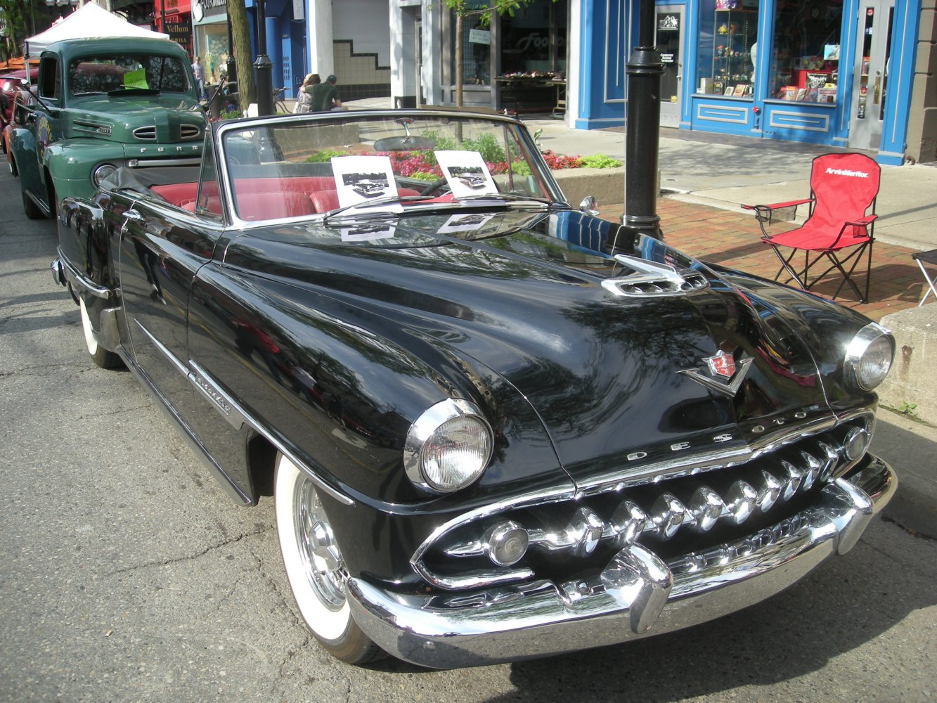 Classic convertible coupe with chrome grille and hood ornament