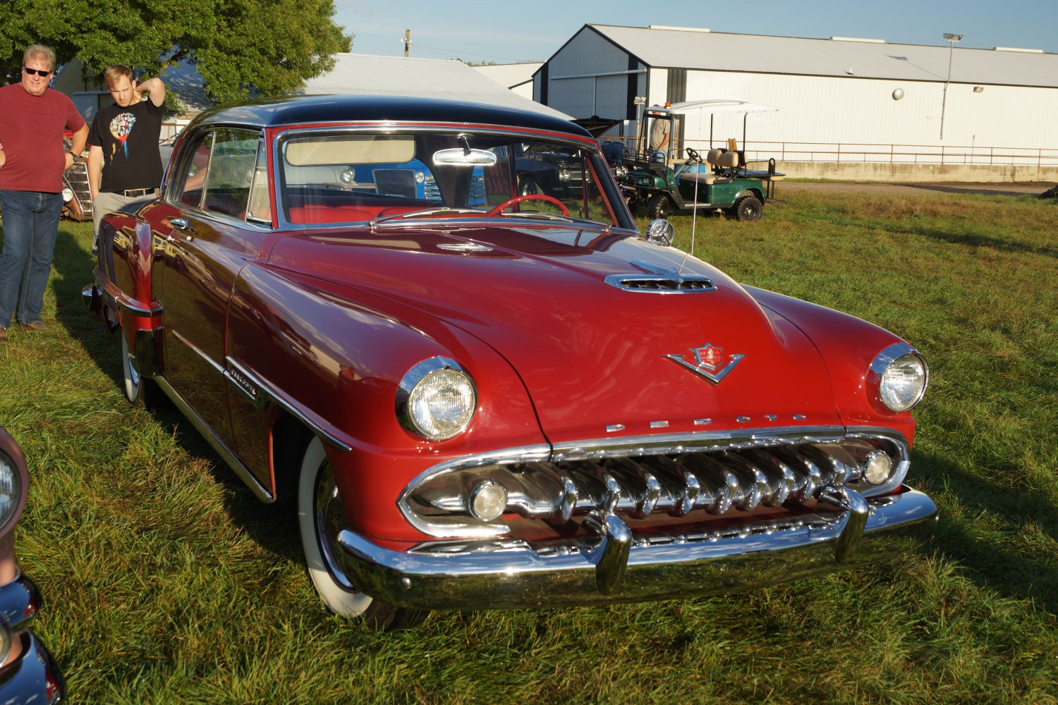 Bold chrome grille with vertical teeth and large rounded headlights