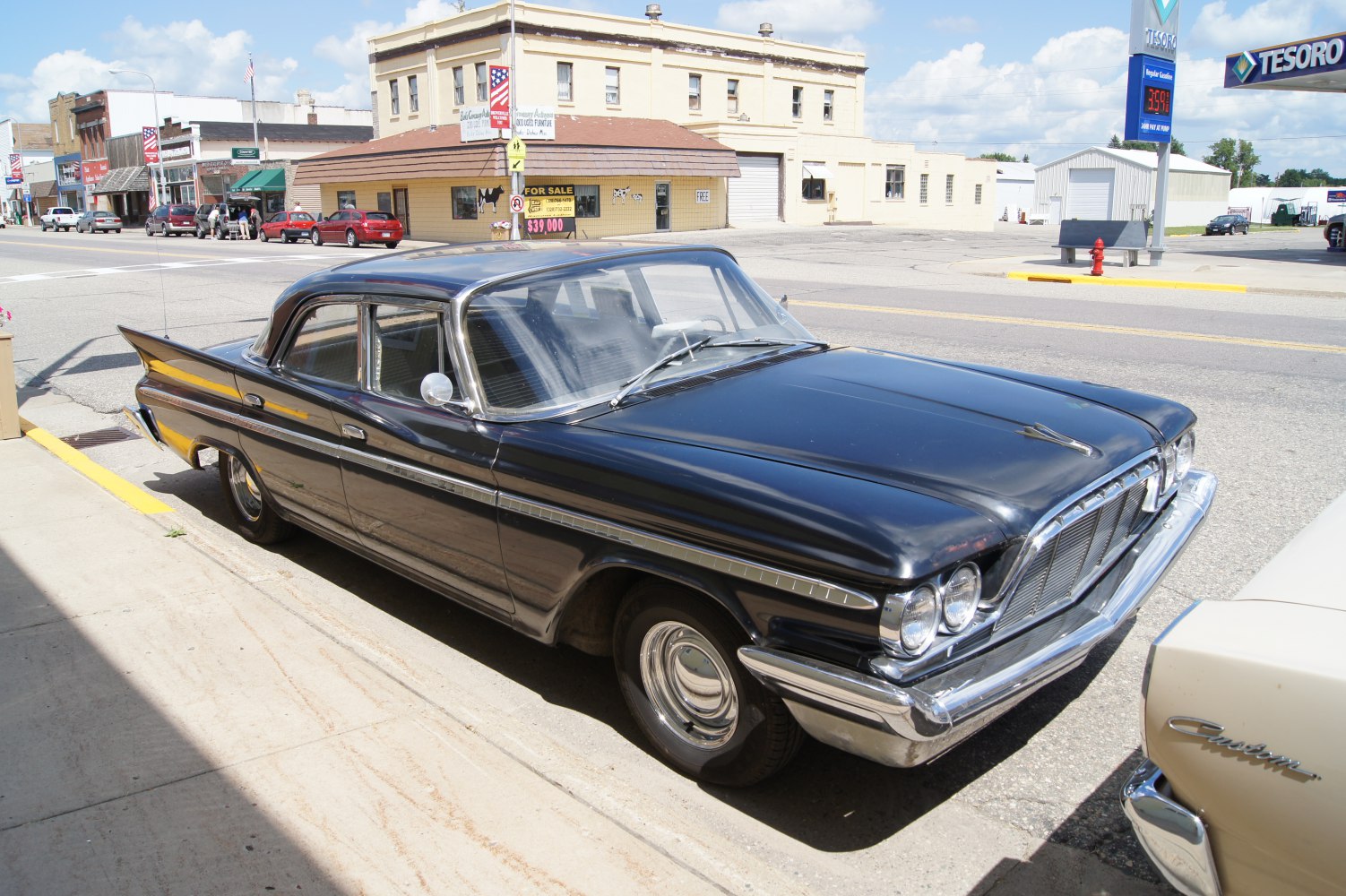 Vintage black sedan with iconic tail fins and chrome trim