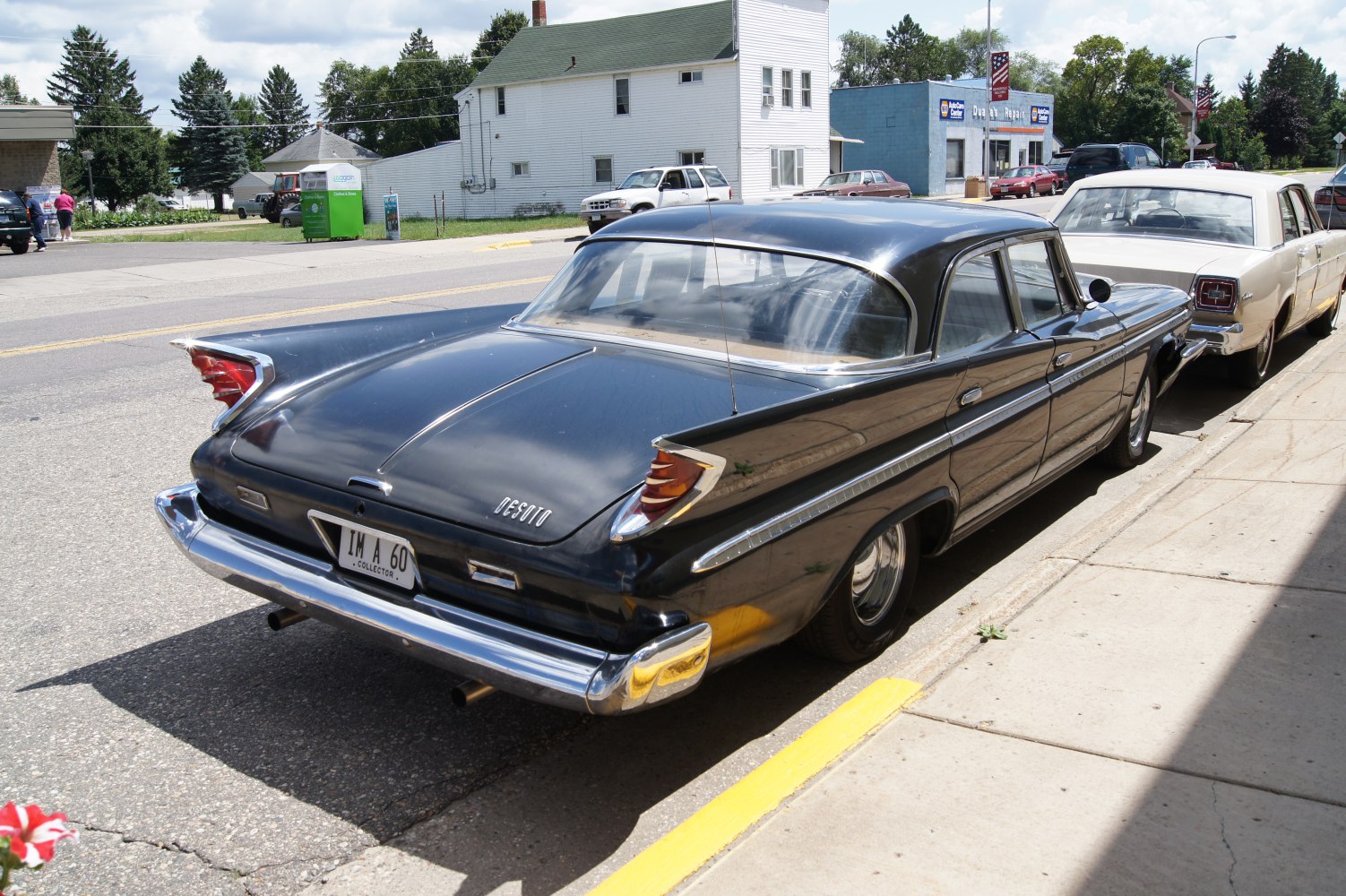 Classic 1960 tailfin sedan with distinctive rear fins and chrome bumper
