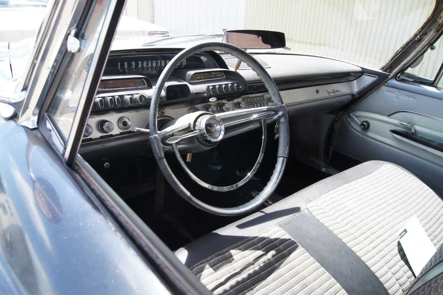 Classic steering wheel and dashboard with retro controls and gauges
