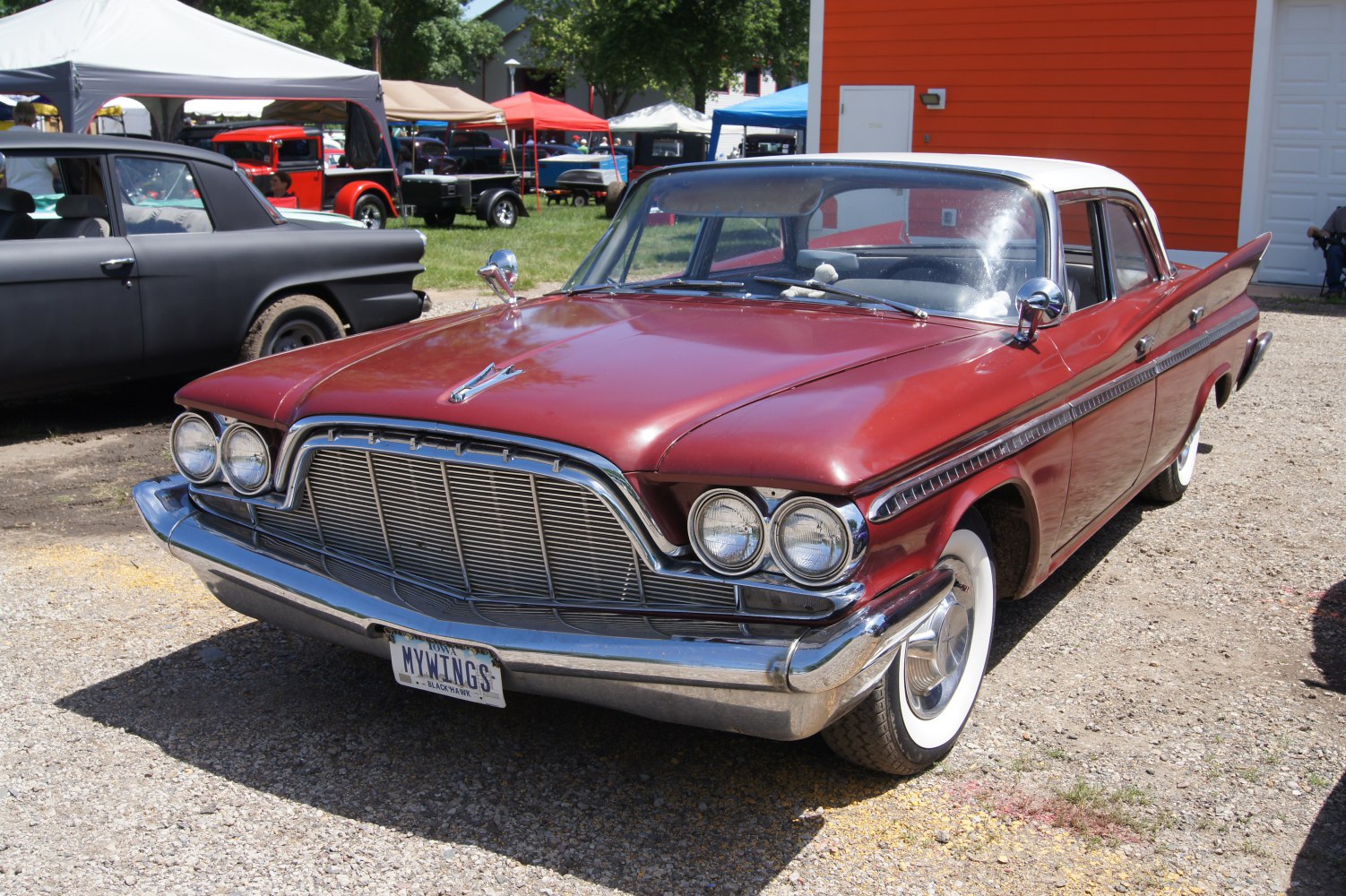 Dual round headlights with big chrome grille and whitewall tires