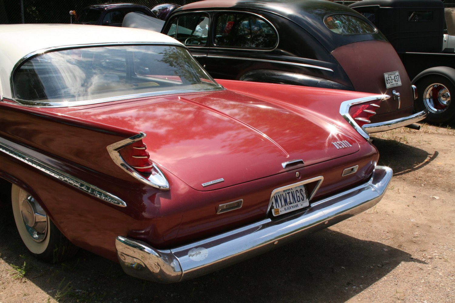 Classic tailfin and chrome bumper on a vintage sedan rear end.