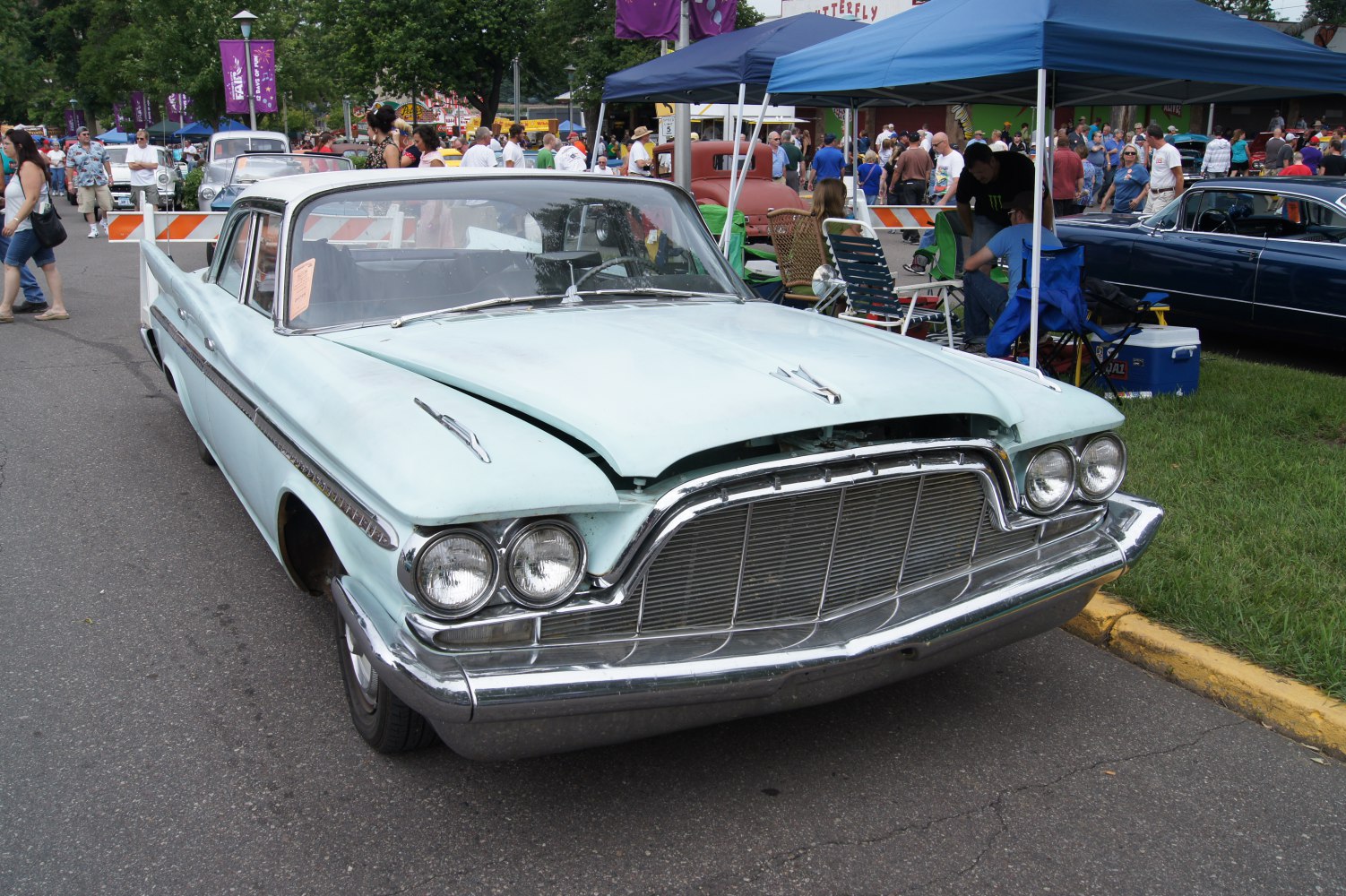 Front view of large sedan with quad headlights and prominent chrome grille