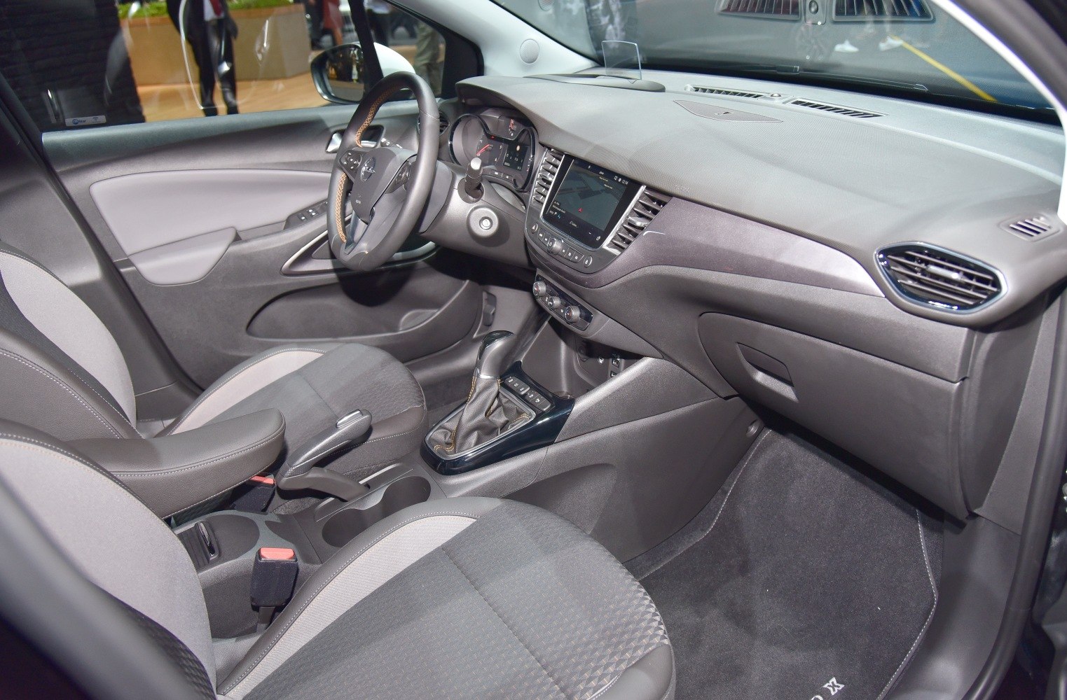 Dashboard, steering wheel, center console, and front seats upholstery detail
