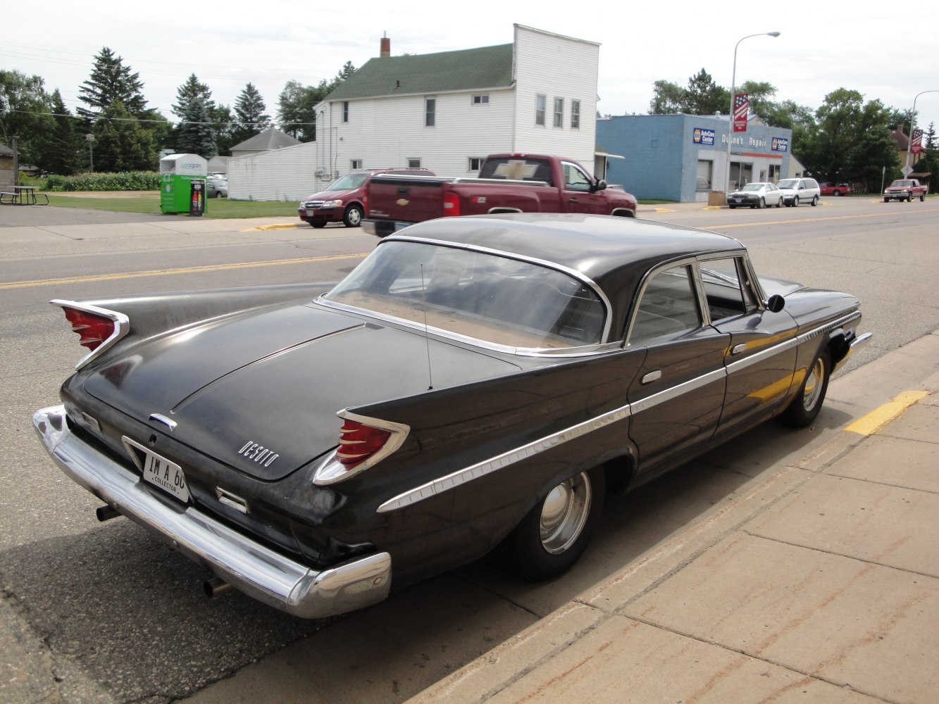 Prominent rear tailfins and extensive chrome trim on a classic vintage sedan.