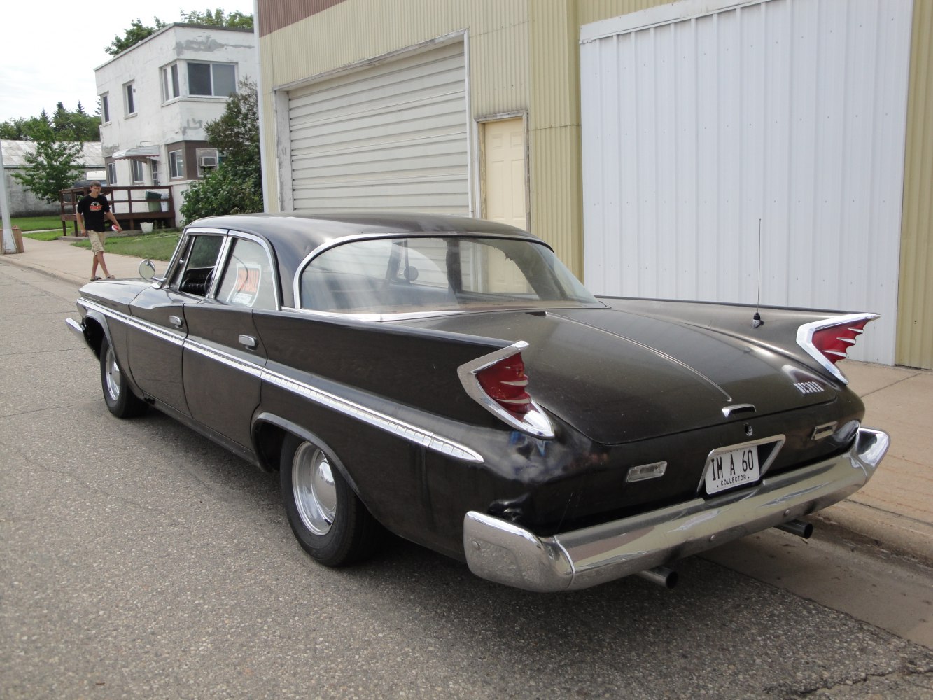 Tall tail fins and chrome bumper on a vintage four-door sedan