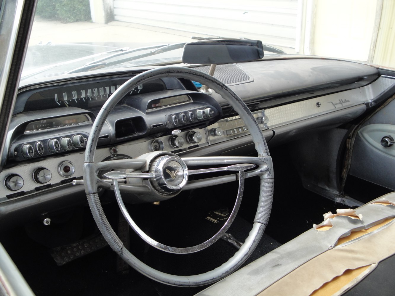 Vintage car steering wheel and retro dashboard with gauges and controls
