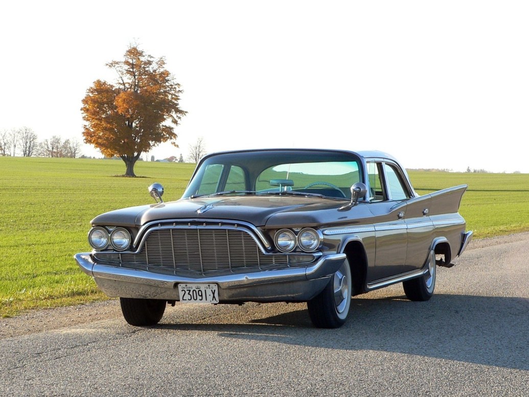 Front view of classic four-door sedan with distinctive grille and tail fins