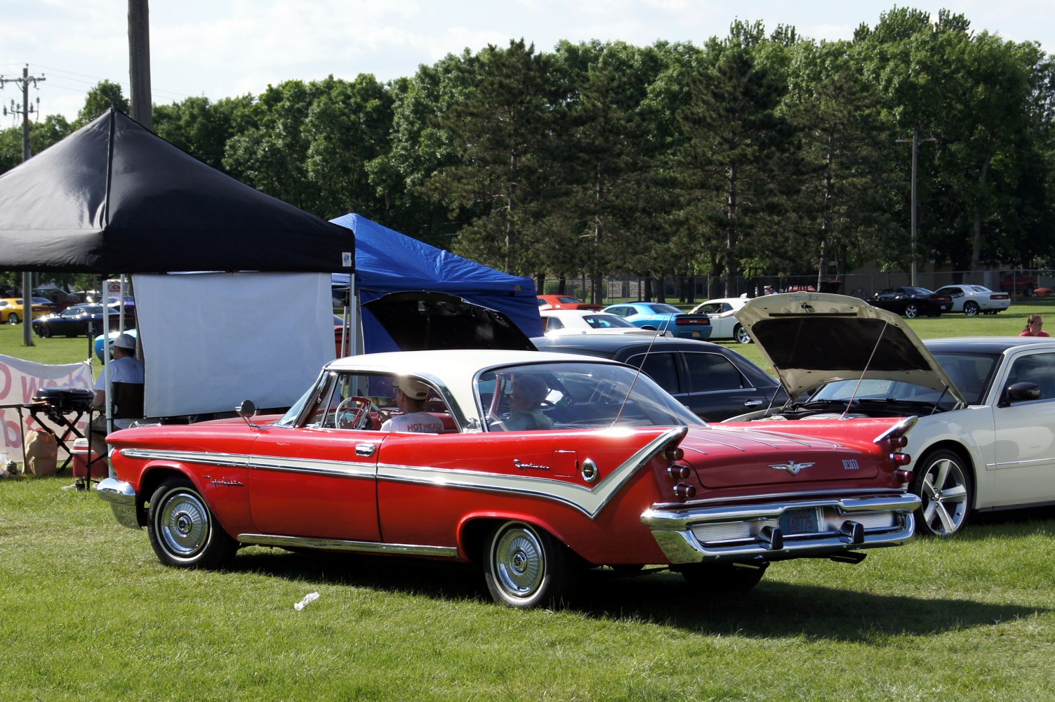 Vintage two-door coupe with prominent tailfins and chrome side trim