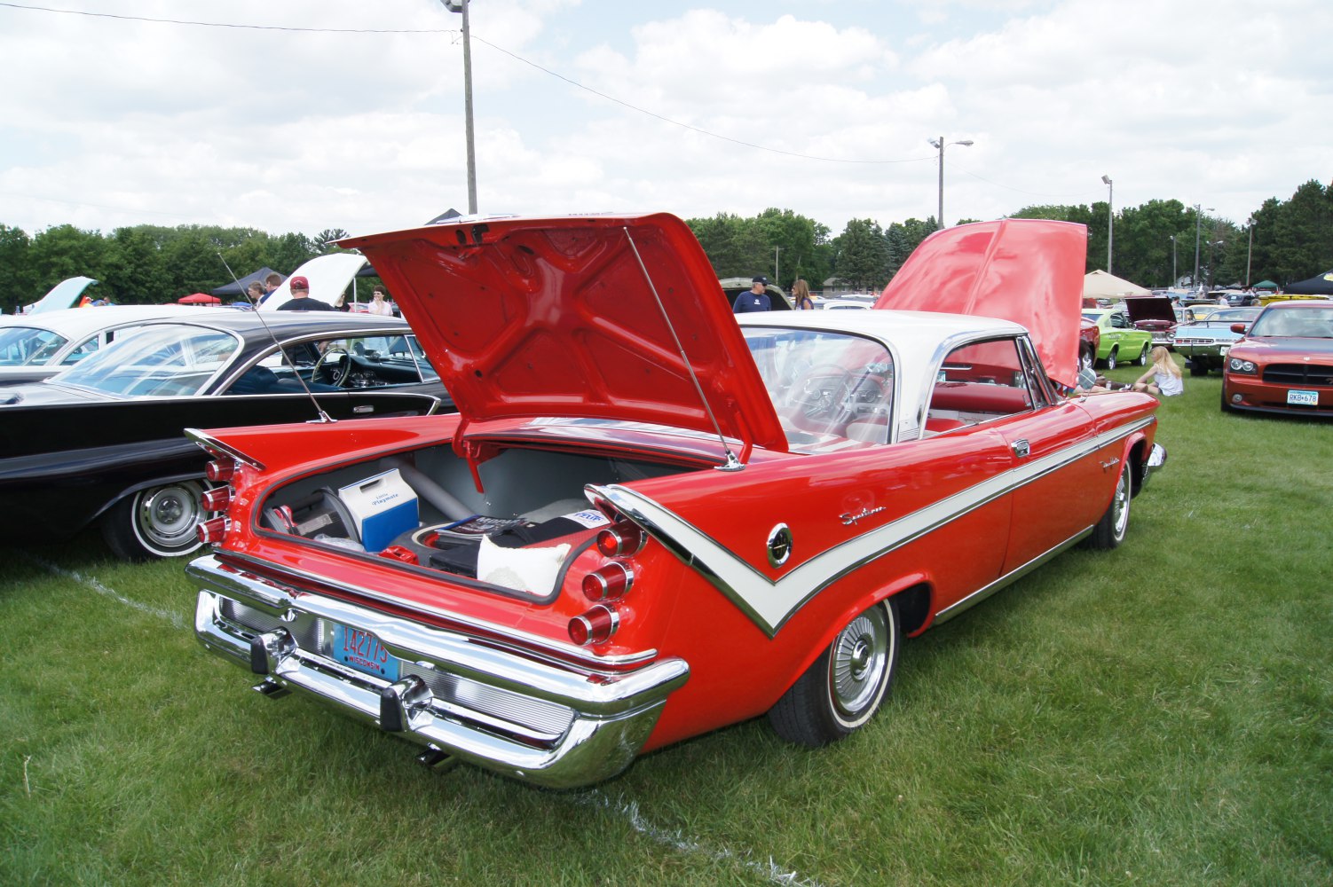 Rear view of classic car with tail fins and open trunk