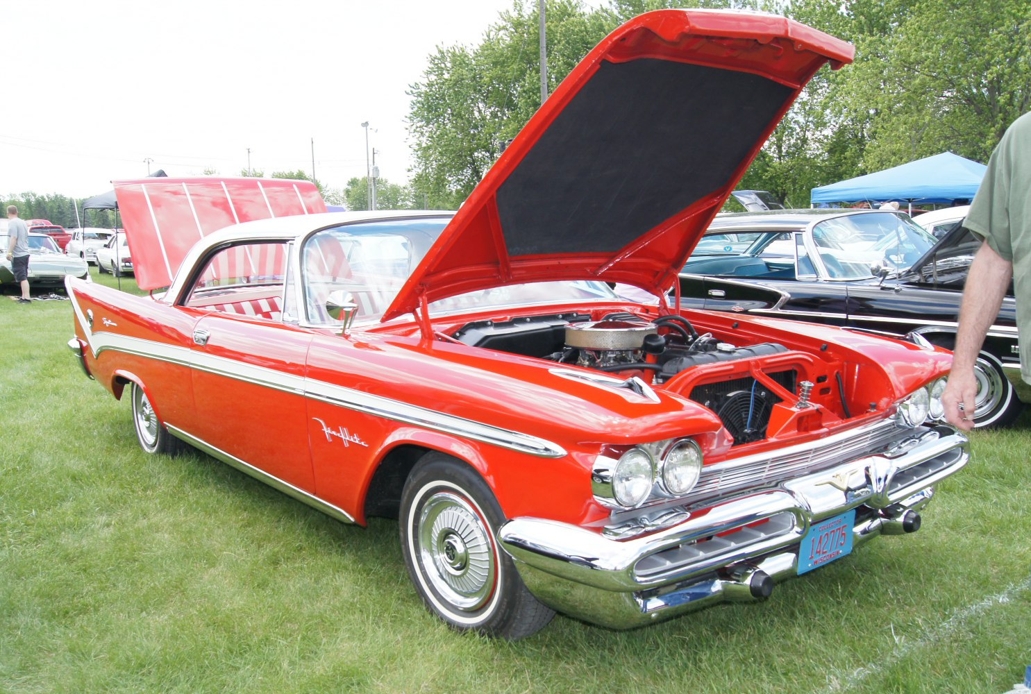 Classic two-door coupe with open hood exposing the engine bay and detailed chrome front.