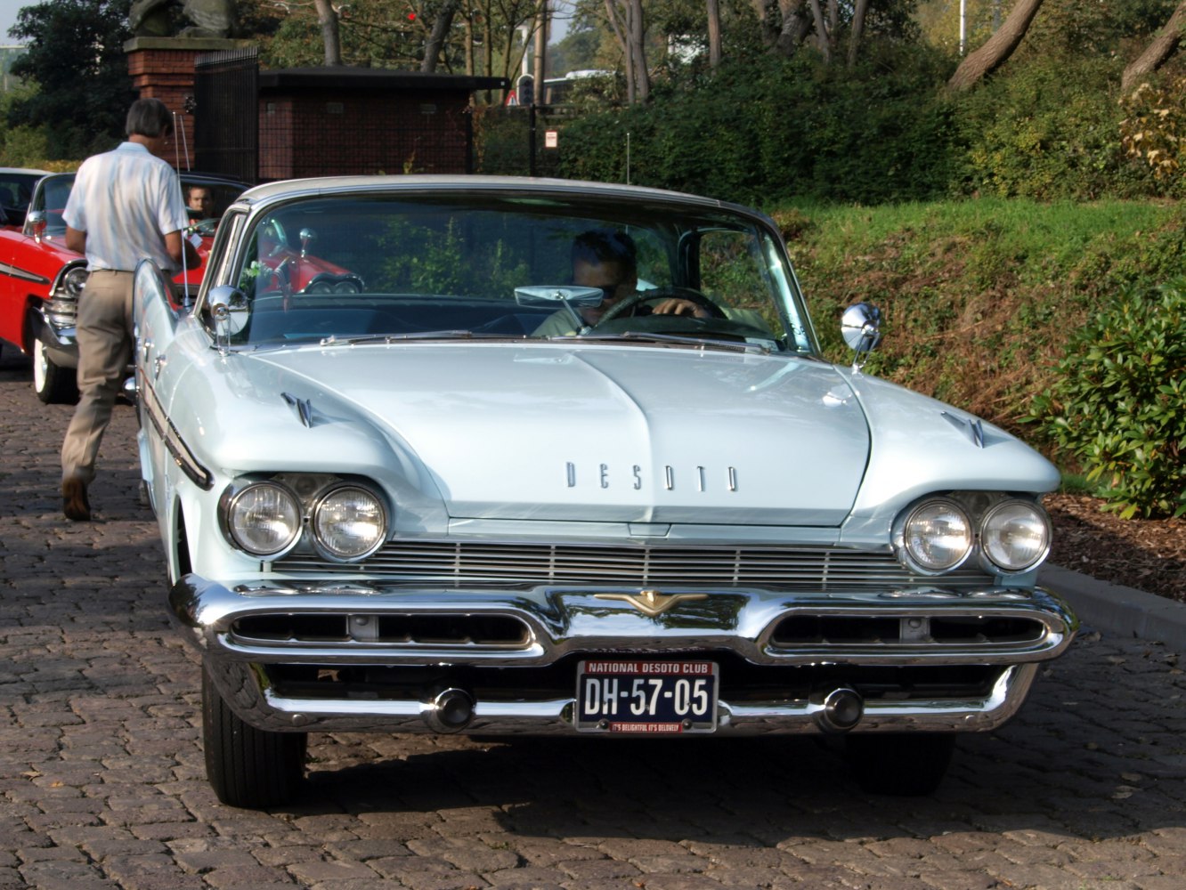 Front view with quad headlights, chrome bumper, and unique hood design