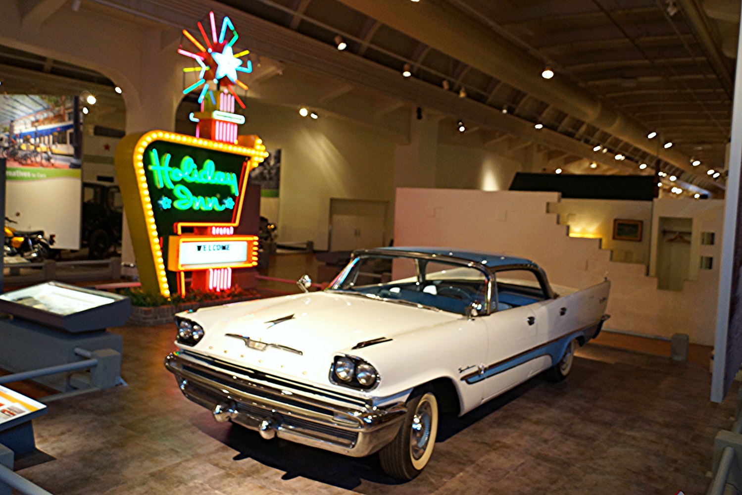 1957 four-door vintage car with dual headlights and chrome grille.
