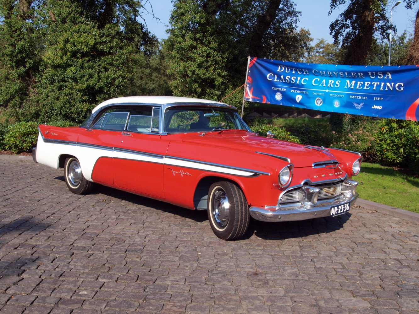 Retro 1950s sedan with prominent tailfins and extensive chrome details