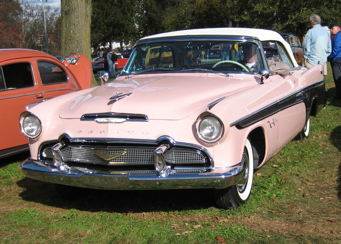 Wide front grille, rounded headlights, chrome trim, convertible roof