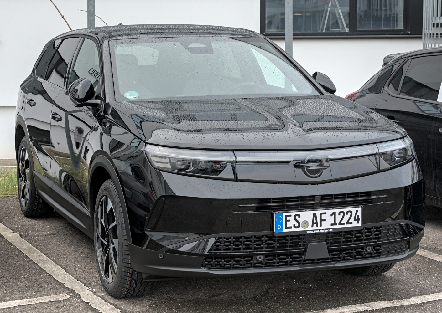 Sleek front view with modern LED headlights and black finish