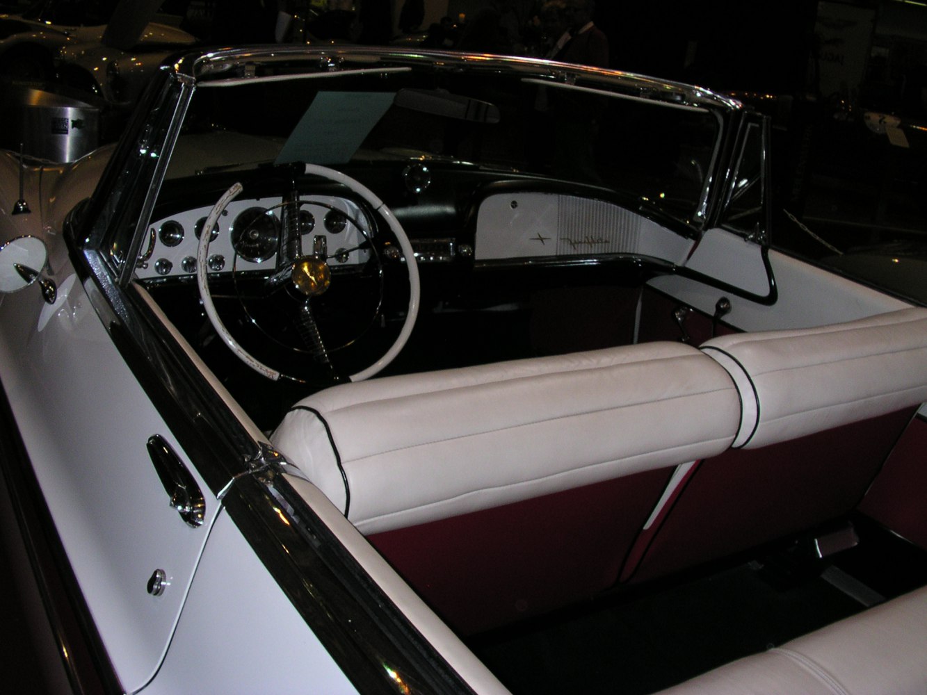 Classic vintage convertible with white leather seats and retro steering wheel