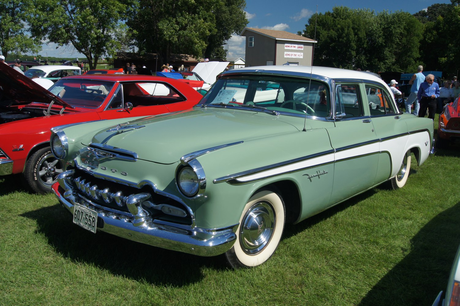 Classic four-door sedan with prominent chrome grille and whitewall tires