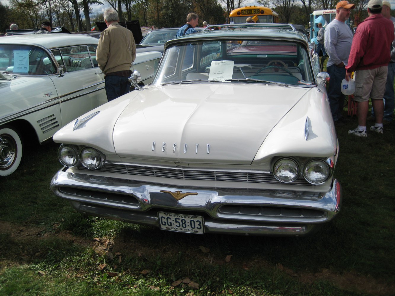 Close-up of vintage car front with dual headlights and chrome bumper