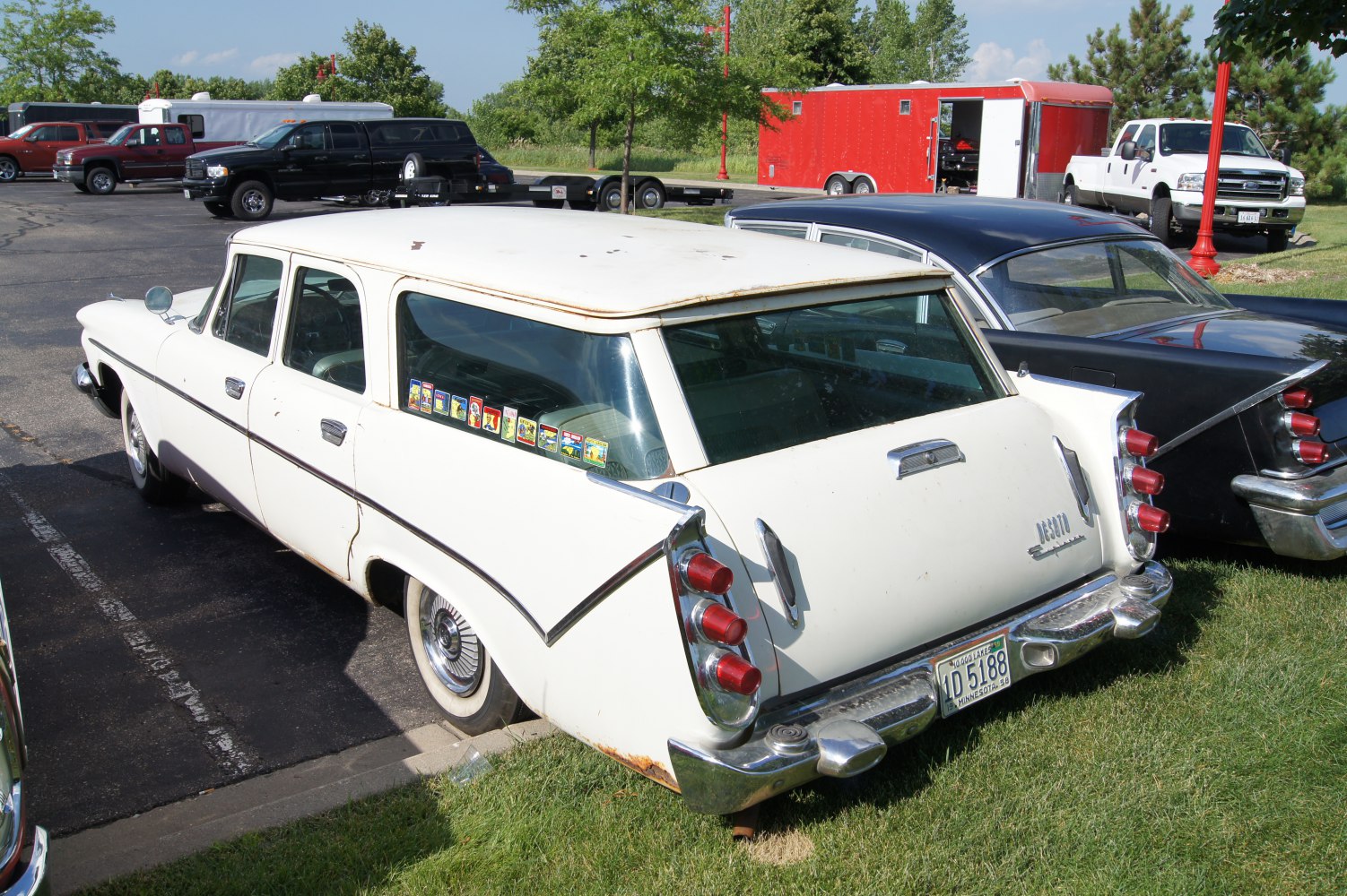 Triple tail fin taillights and chrome rear bumper on a vintage station wagon.