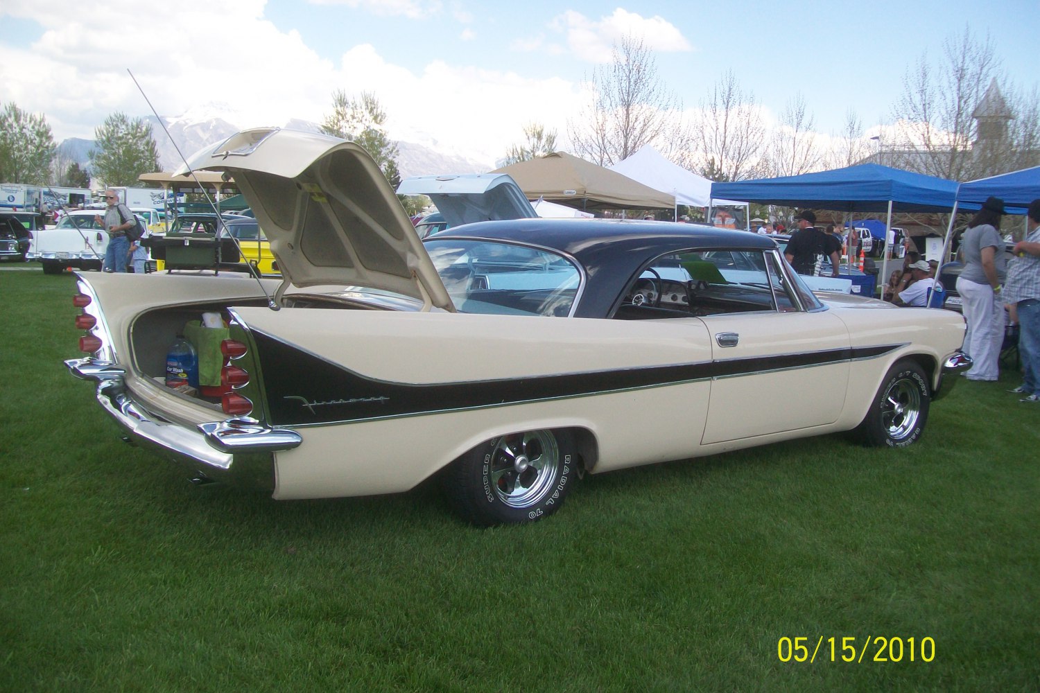 Two-door coupe with open trunk and tri-fin tail lights