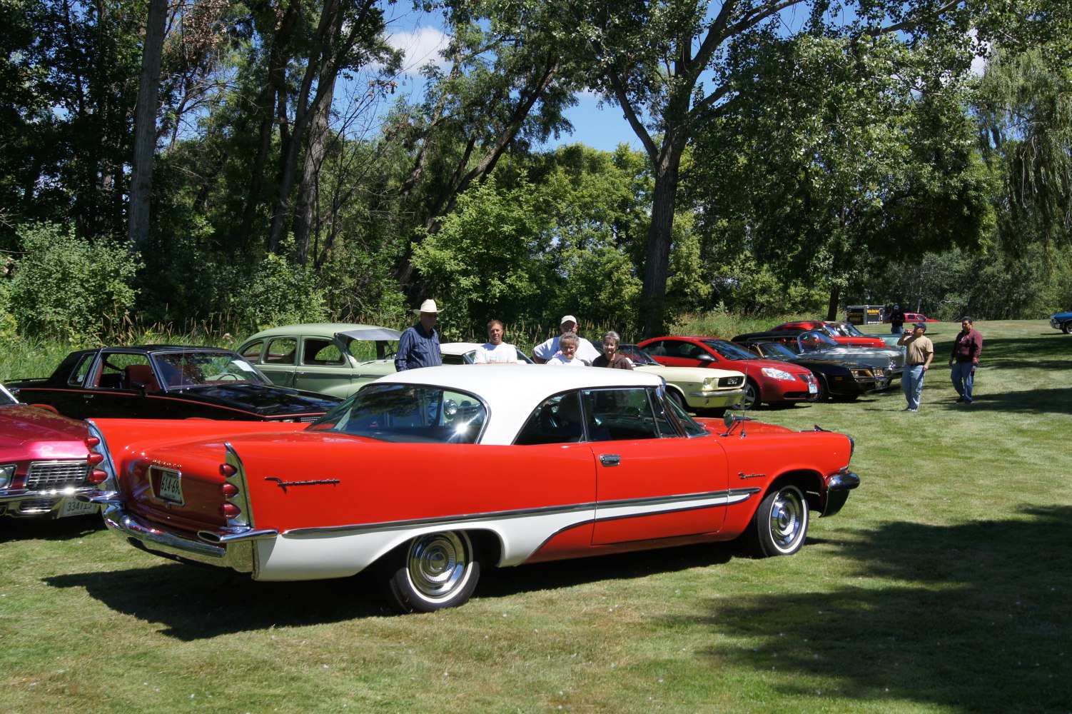 2-door red and white hardtop with prominent rear tailfins and chrome accents