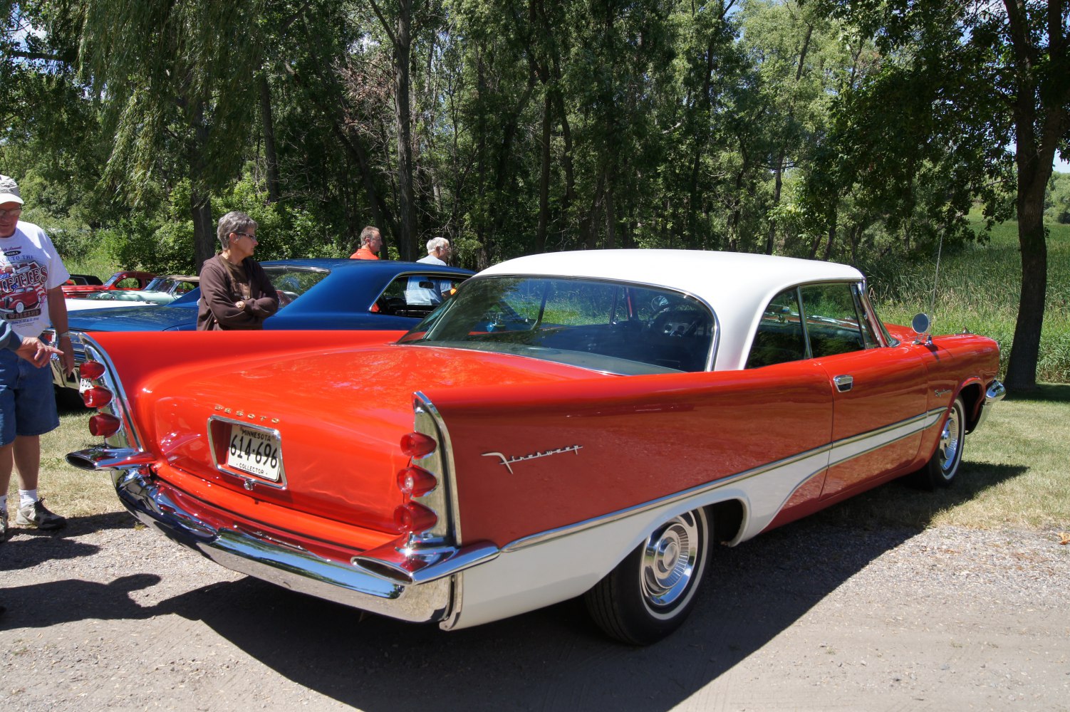 Two-tone coupe with large rear tailfins, chrome bumper, and dual vertical taillights