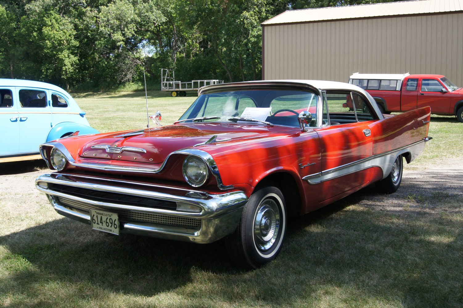 1950s 2-door car with chrome grille and fins